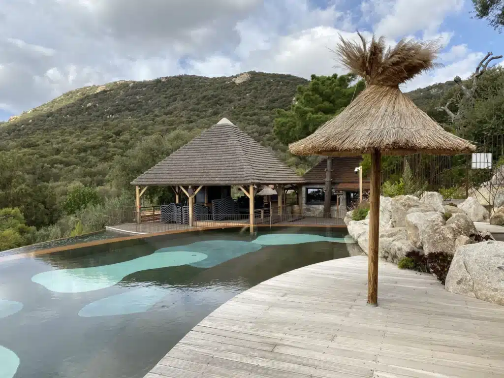 Parasols tropicaux et paillote exotique en roseau Installation de parasols camarguais et d'une paillote exotique en roseau de Camargue dans un camping en Corse avec vue mer